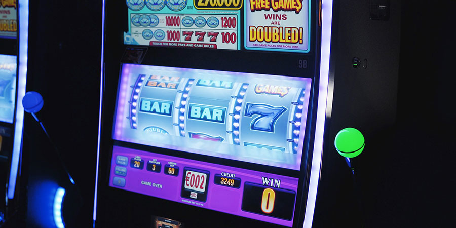 slot machine with purple lighting inside a casino